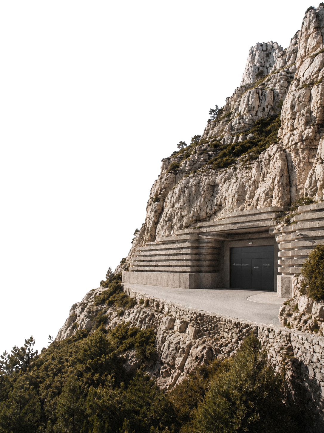 Camouflaged mountain bunker entrance built into rock